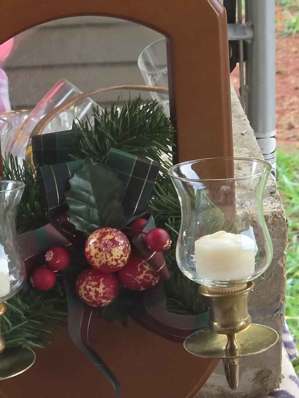 Wall-Mounted Brown Mirror Candle Sconce with Holiday Greenery